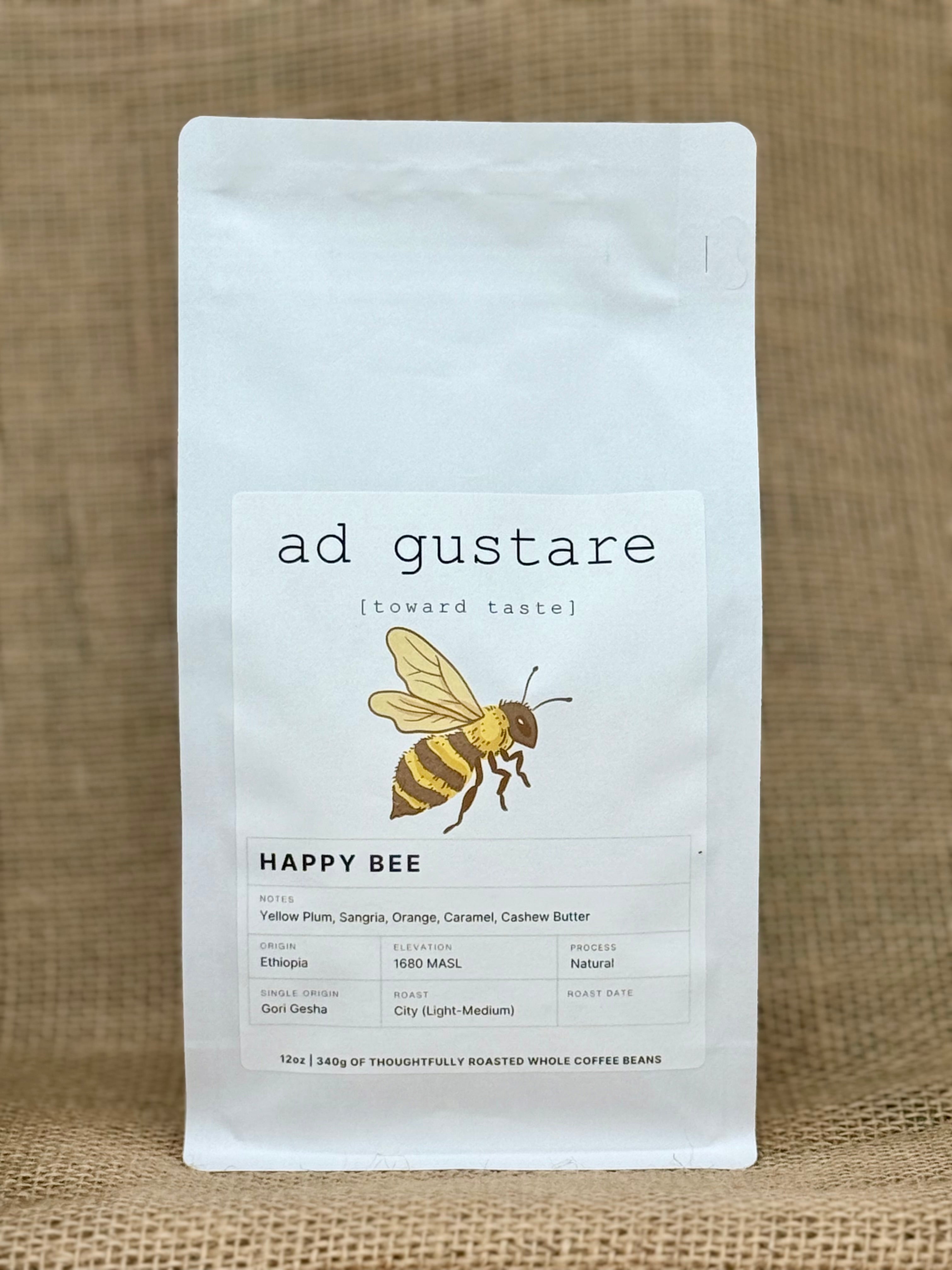 Coffee package labeled 'Happy Bee' with a bee illustration on a textured brown background