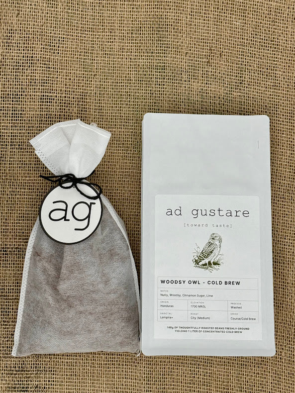 ad gustare Woodsy Owl Cold brew sachet bag on a textured baxkground