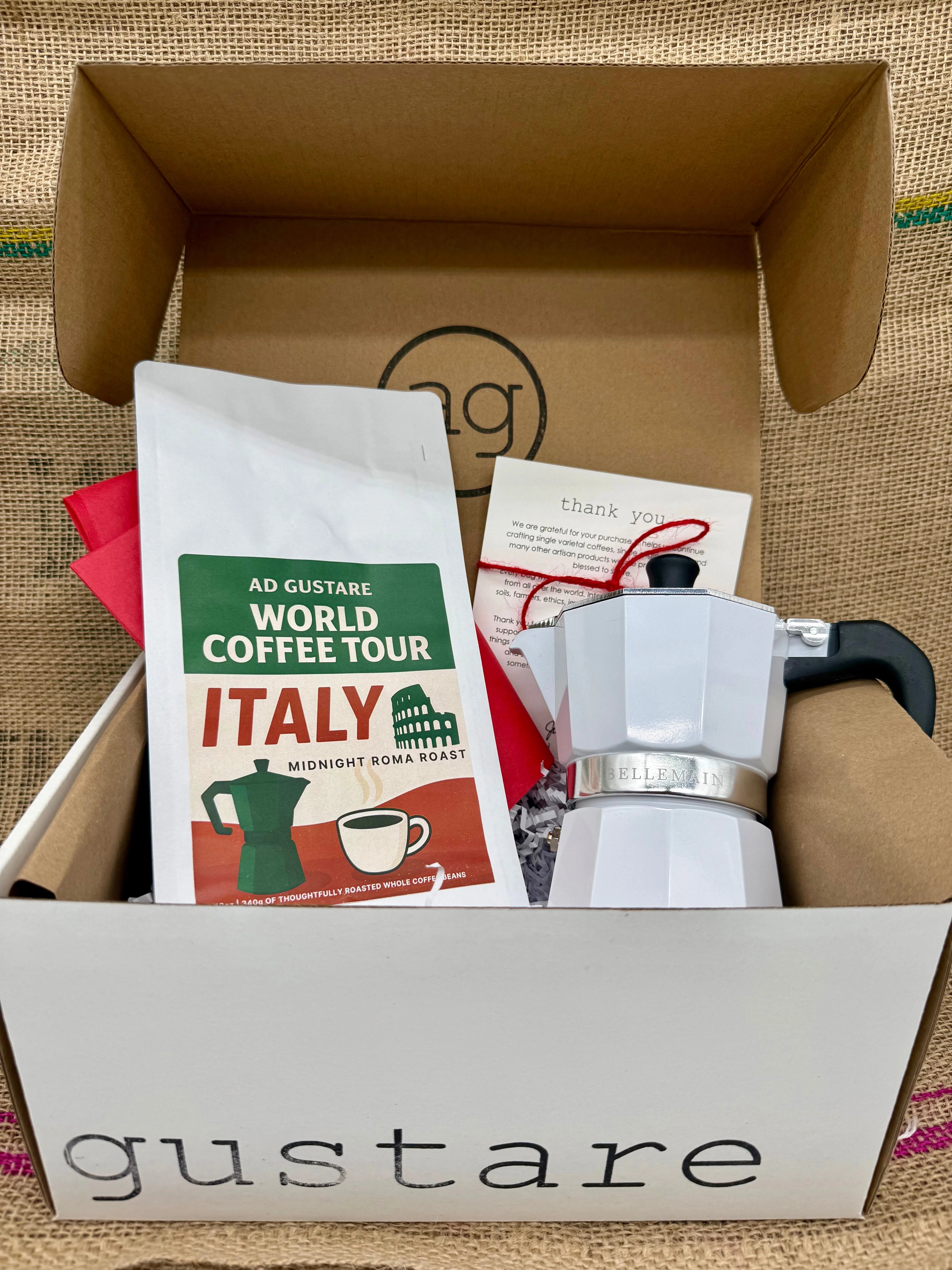 Box containing a coffee-themed product with 'gustare' branding on a textured surface.